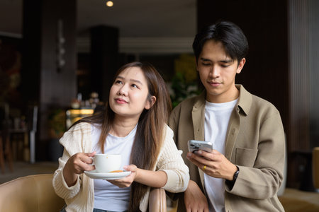 Young happy couple drinking coffee in cafe restaurantの写真素材