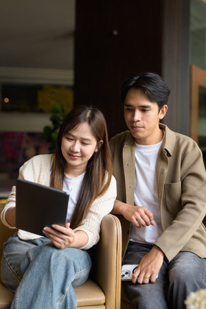 Business couple using tablet computer together in cafe restaurantの写真素材