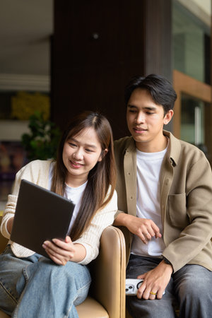 Business couple using tablet computer together in cafe restaurantの写真素材