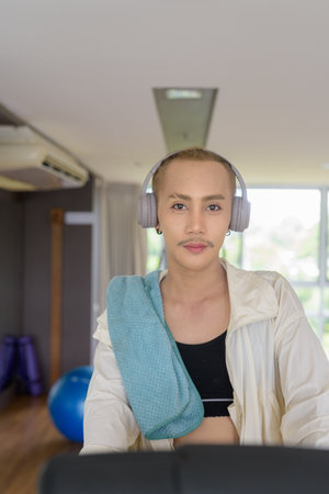Non-binary Asian person exercising in gym wearing sportswearの写真素材