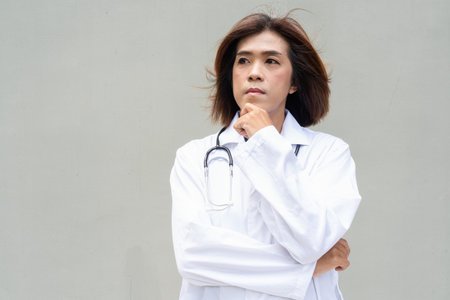 Portrait of Asian transgender non binary doctor with stethoscope. Diversity in healthcare.の写真素材
