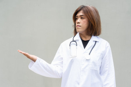 Portrait of Asian transgender non binary doctor with stethoscope. Diversity in healthcare.の写真素材