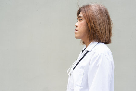 Portrait of Asian transgender non binary doctor with stethoscope. Diversity in healthcare.の写真素材