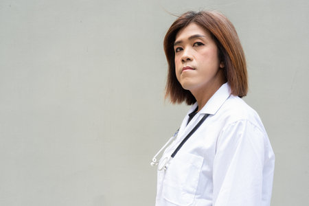 Portrait of Asian transgender non binary doctor with stethoscope. Diversity in healthcare.の写真素材