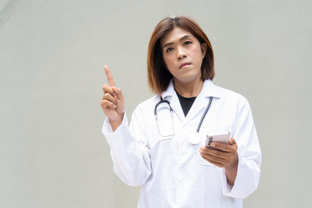 Portrait of Asian transgender non binary doctor with stethoscope. Diversity in healthcare.の写真素材