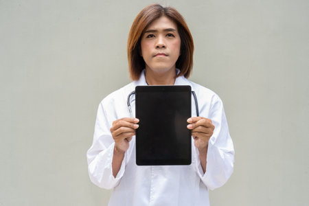 Portrait of Asian transgender non binary doctor with stethoscope. Diversity in healthcare.の写真素材