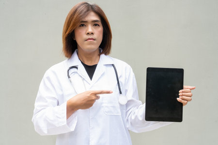 Portrait of Asian transgender non binary doctor with stethoscope. Diversity in healthcare.の写真素材