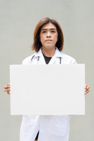 Portrait of Asian transgender non binary doctor with stethoscope. Diversity in healthcare.の写真素材