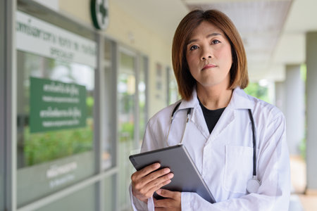 Portrait of Asian transgender non binary doctor with stethoscope. Diversity in healthcare.の写真素材
