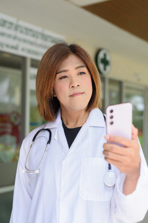 Portrait of Asian transgender non binary doctor with stethoscope. Diversity in healthcare.の写真素材