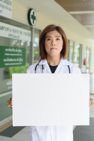 Portrait of Asian transgender non binary doctor with stethoscope. Diversity in healthcare.の写真素材
