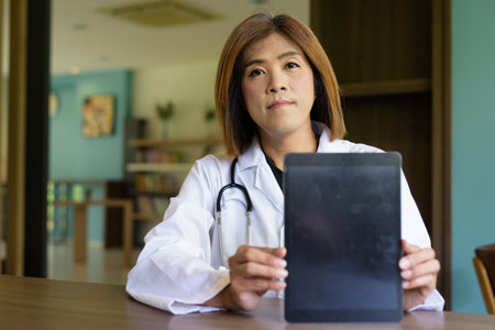 Portrait of Asian transgender non binary doctor with stethoscope. Diversity in healthcare.の写真素材