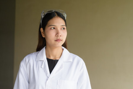 Young Asian scientist woman wearing lab coat and gogglesの写真素材