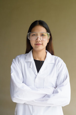 Young Asian scientist woman wearing lab coat and gogglesの写真素材