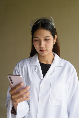 Young Asian scientist woman wearing lab coat and gogglesの写真素材
