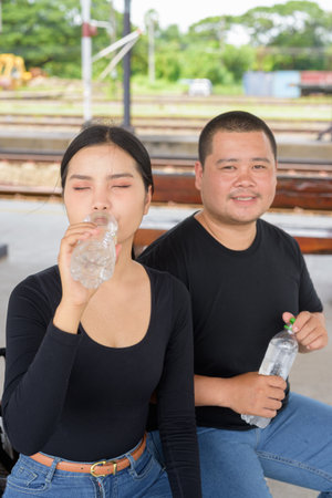 Young Asian couple in train station togetherの写真素材