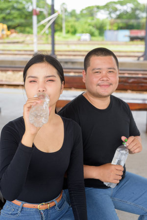 Young Asian couple in train station togetherの写真素材