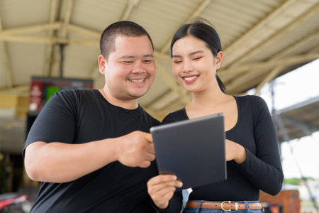 Young Asian couple in train station togetherの写真素材
