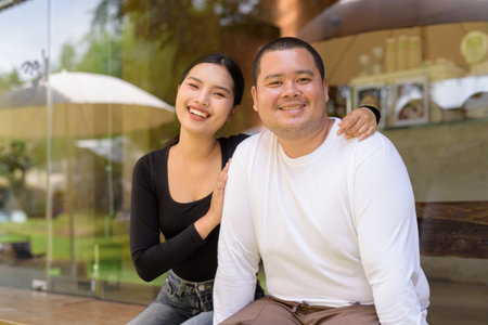 Happy Asian couple smiling in cafe restaurant togetherの写真素材