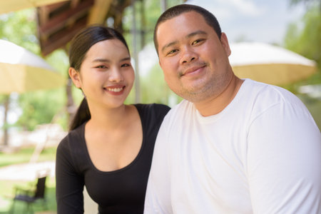 Happy Asian couple smiling in cafe restaurant togetherの写真素材