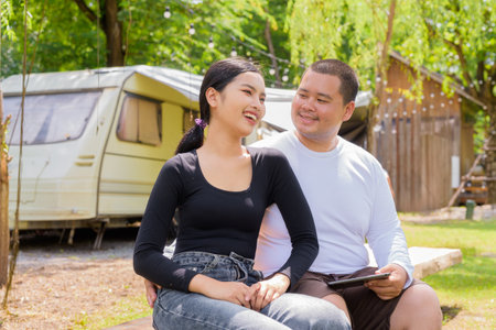 Asian couple camping in campground with their motorhome van carの写真素材