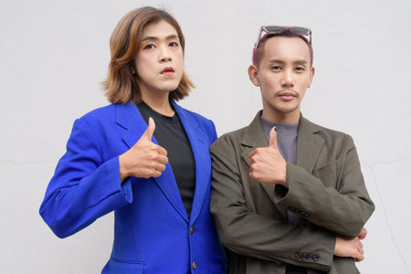 Gender inclusive Asian business team couple against white background