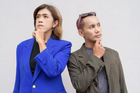 Gender inclusive Asian business team couple against white background