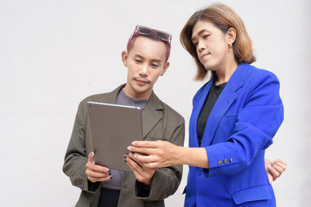 Gender inclusive Asian business team couple against white backgroundの写真素材