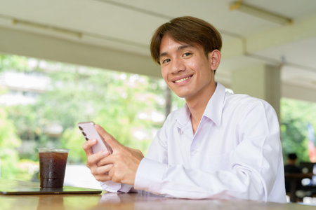 Non binary Asian university student in college campus
