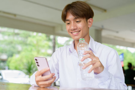 Non binary Asian university student in college campus