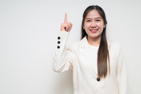 Studio portrait of young Asian woman wearing suit ready for business against white backgroundの写真素材