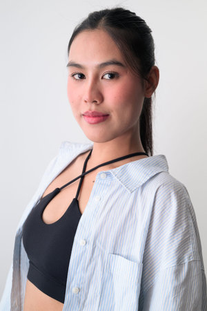 Studio portrait of young cute Asian woman against white background