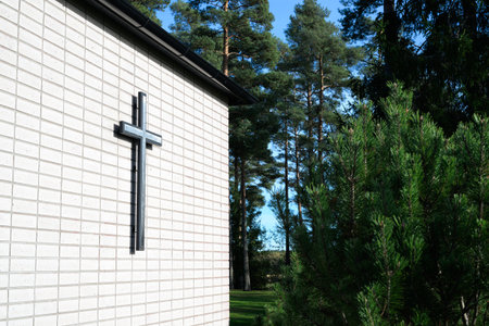 Cross on the wall of the church in the forest. Religion concept.の写真素材
