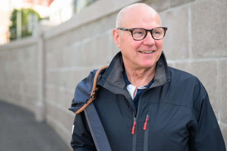 Portrait of a smiling senior man with eyeglasses in the cityの写真素材