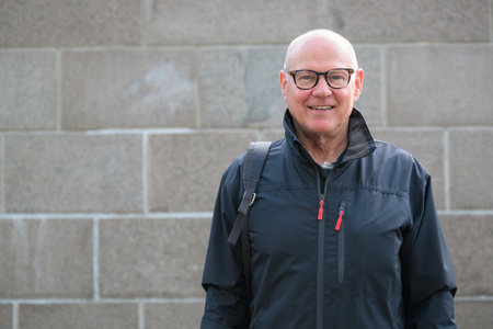 Portrait of a smiling Scandinavian senior man wearing sportswear in the cityの写真素材