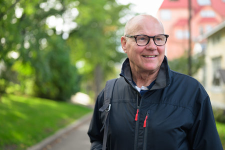 Portrait of a smiling Nordic senior man standing outdoorsの写真素材
