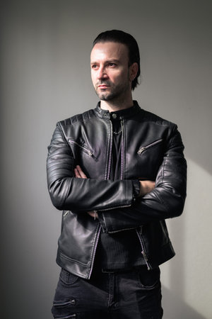Confident bearded man wearing black leather jacketの写真素材