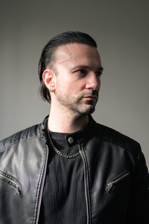 Confident bearded man wearing black leather jacket