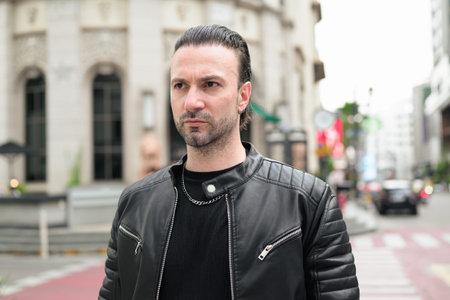Confident bearded man wearing black leather jacket