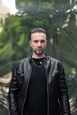 Confident bearded man wearing black leather jacketの写真素材