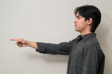 Portrait of handsome Young Asian Thai man in early 20s against white backgroundの写真素材