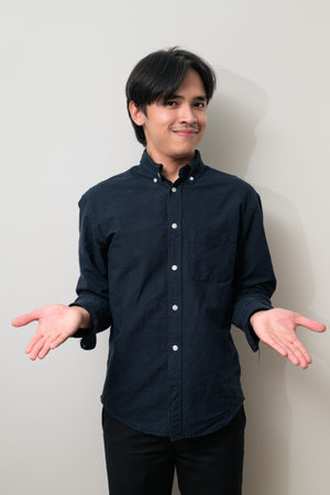 Portrait of handsome Young Asian Thai man in early 20s against white background