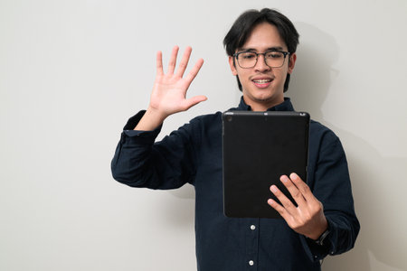 Portrait of handsome Young Asian Thai man in early 20s against white backgroundの写真素材