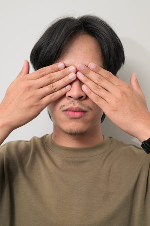 Portrait of Young Asian Thai man in early 20s against white background