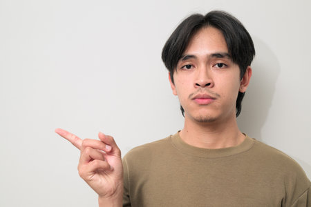 Portrait of handsome Young Asian Thai man in early 20s against white backgroundの写真素材