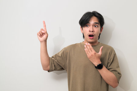 Portrait of handsome Young Asian Thai man in early 20s against white backgroundの写真素材