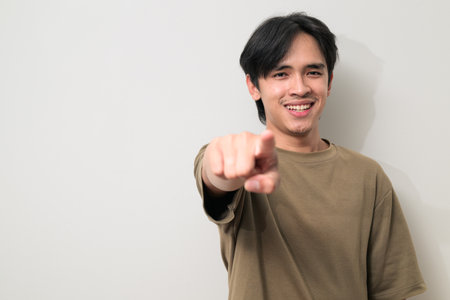 Portrait of handsome Young Asian Thai man in early 20s against white backgroundの写真素材