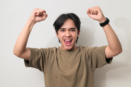 Portrait of handsome Young Asian Thai man in early 20s against white backgroundの写真素材