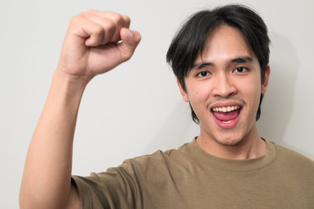 Portrait of handsome Young Asian Thai man in early 20s against white backgroundの写真素材