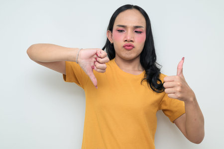 Studio portrait of a young Thai transgender individual with makeup and long hair. Concept of gender...
